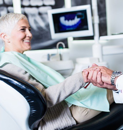 Woman shaking hands with periodontist