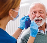 Man smiles at dentist