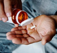 a person preparing to take a pill
