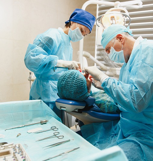 Team carefully performing osseous surgery