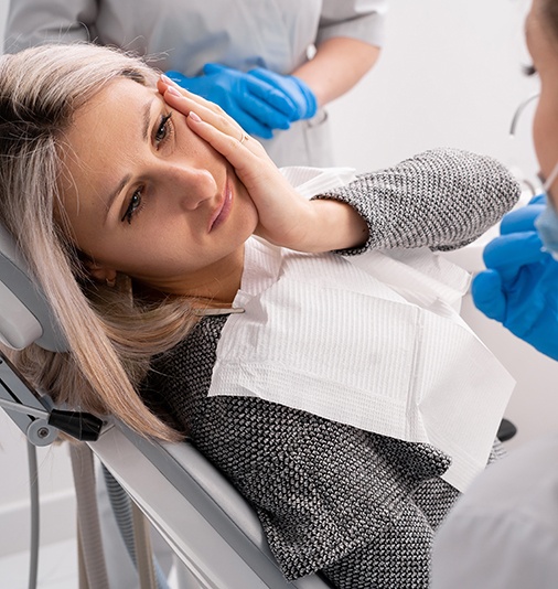 Woman with a toothache at the dentist
