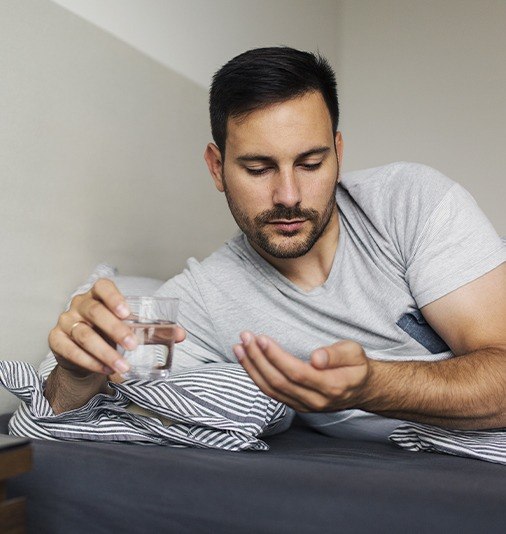 Man taking an oral conscious dental sedation pill