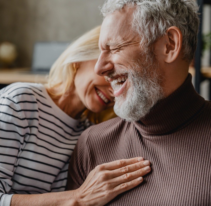 Man and woman sharing healthy smile after periodontal services