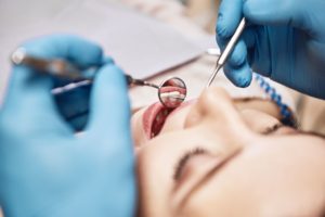 Facial close up of a woman in a dental chair having an examination