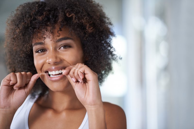 Patient smiling at home with dental implants